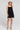 Front view of a woman wearing the Saltwater Luxe Valey Black Mini Dress on a neutral background
