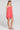 Side angle view of a woman wearing the Saltwater Luxe Valey Cranberry Mini Dress on a neutral background