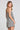 Back view of a woman wearing the Saltwater Luxe Viena Tank on a neutral background
