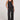 Full body front view of a woman wearing the Saltwater Luxe  Woven Black Pull On Pant on a neutral background