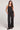 Full body front view of a woman wearing the Saltwater Luxe  Woven Black Pull On Pant on a neutral background