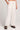Front view of a woman wearing the Saltwater Luxe Woven Ecru Pull On Pant on a neutral background with hand in one pocket