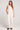 Full body front view of a woman wearing the Saltwater Luxe Woven Ecru Pull On Pant on a neutral background