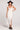 Front view of a woman wearing the Saltwater Luxe Woven Ecru Tank Midi Dress on a neutral background