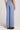 Back view of a woman wearing the Saltwater Luxe Woven Worn Blue Pull On Pant on a neutral background