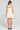 Back view of a woman wearing the Saltwater Luxe Zevya Salt Mini Dress on a neutral background
