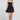 Front view of a woman wearing the Saltwater Luxe Zurina Black Mini Dress on a neutral background